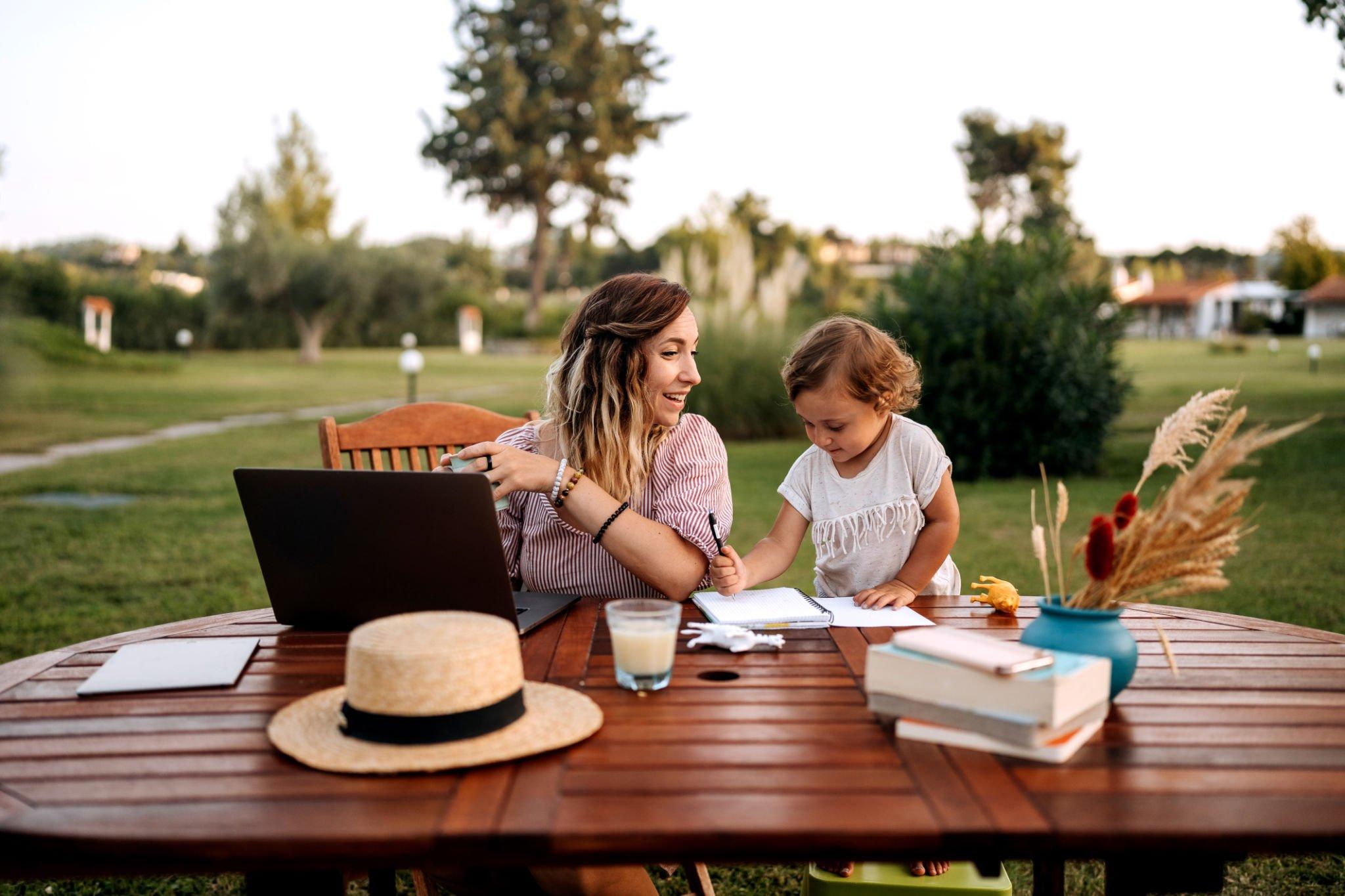 mature Children outside have a picnic desk